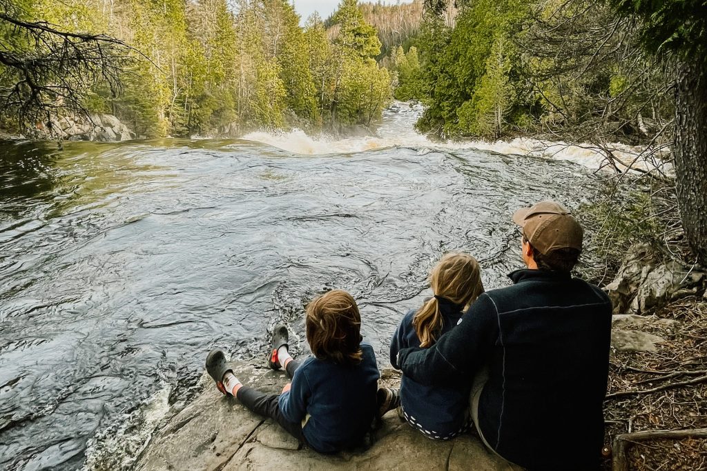 Family looking over the falls at George Crosby Manitou State Park